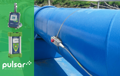 A large water pipe fitted with a non-invasive clamp on ultrasonic flow meter to determine rate of flow within the pipe